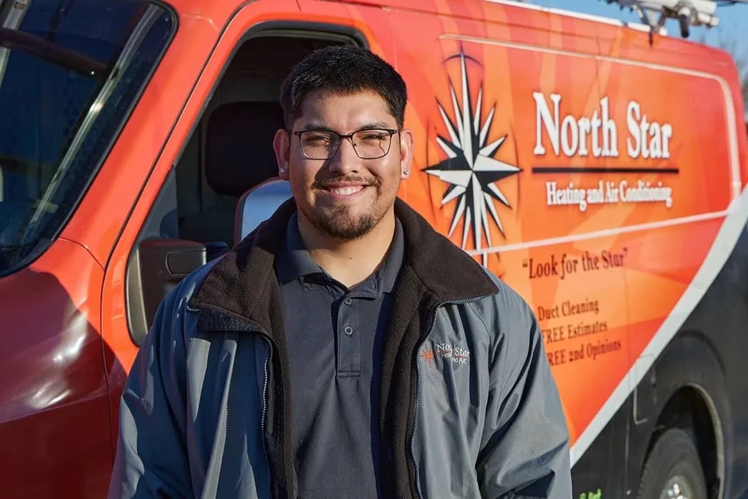 North Star technician standing in front of branded service van in Utah County