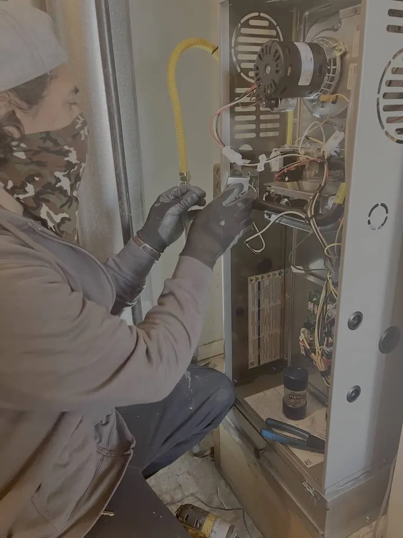 Technician working on a furnace in a modern home