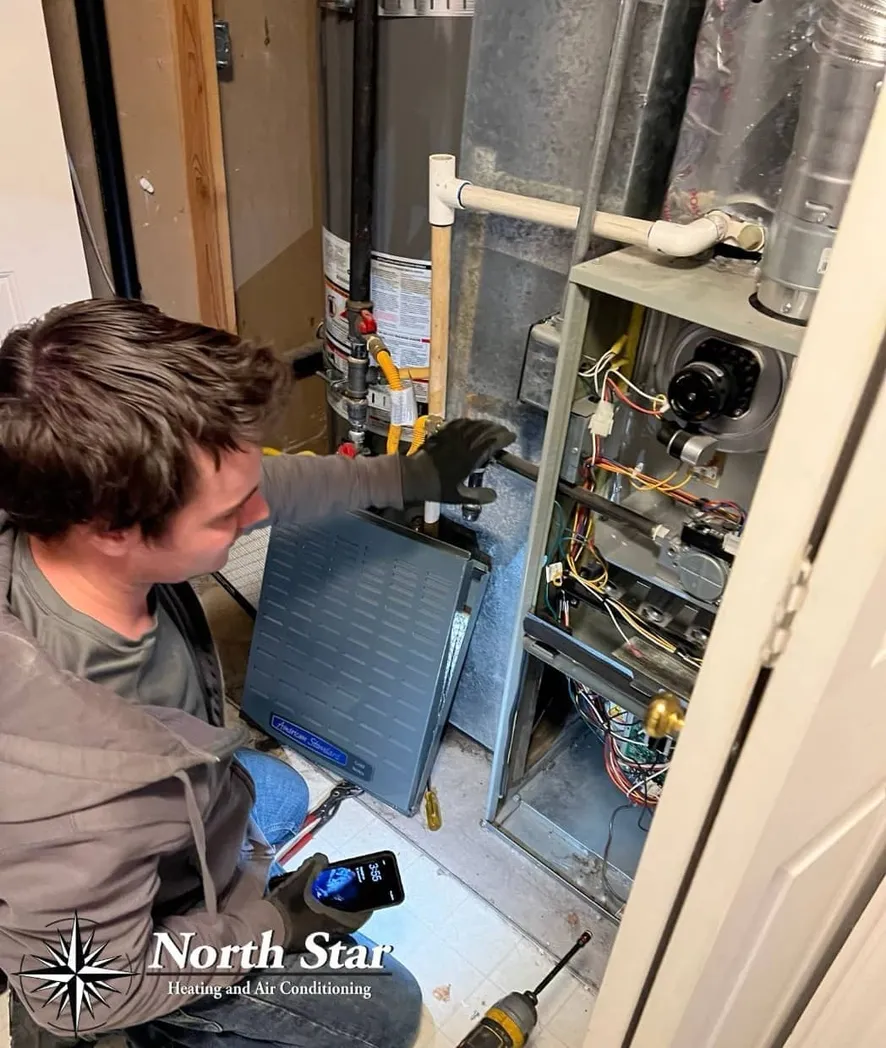 North Star Heating & Air Conditioning technician performing AC repair in Clearfield, UT