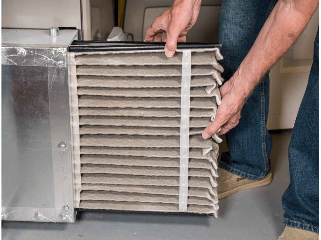 man changing dirty air filter