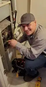 A North Star Heating & Air Conditioning HVAC technician working on an HVAC system for repairs.