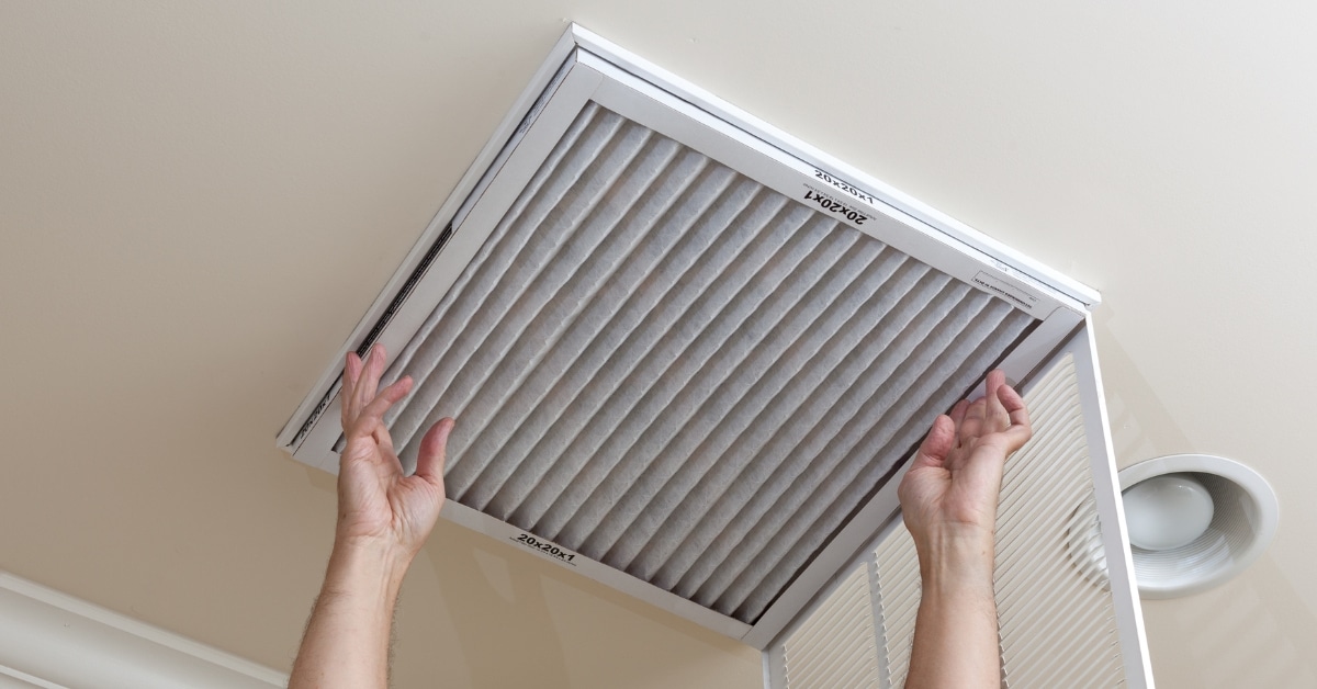 Man reaching up to open filter holder
